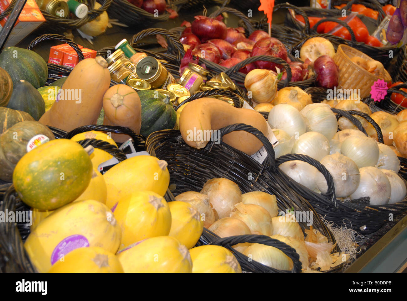 Vegetables stacked in baskets in the produce aisle of a grocery store