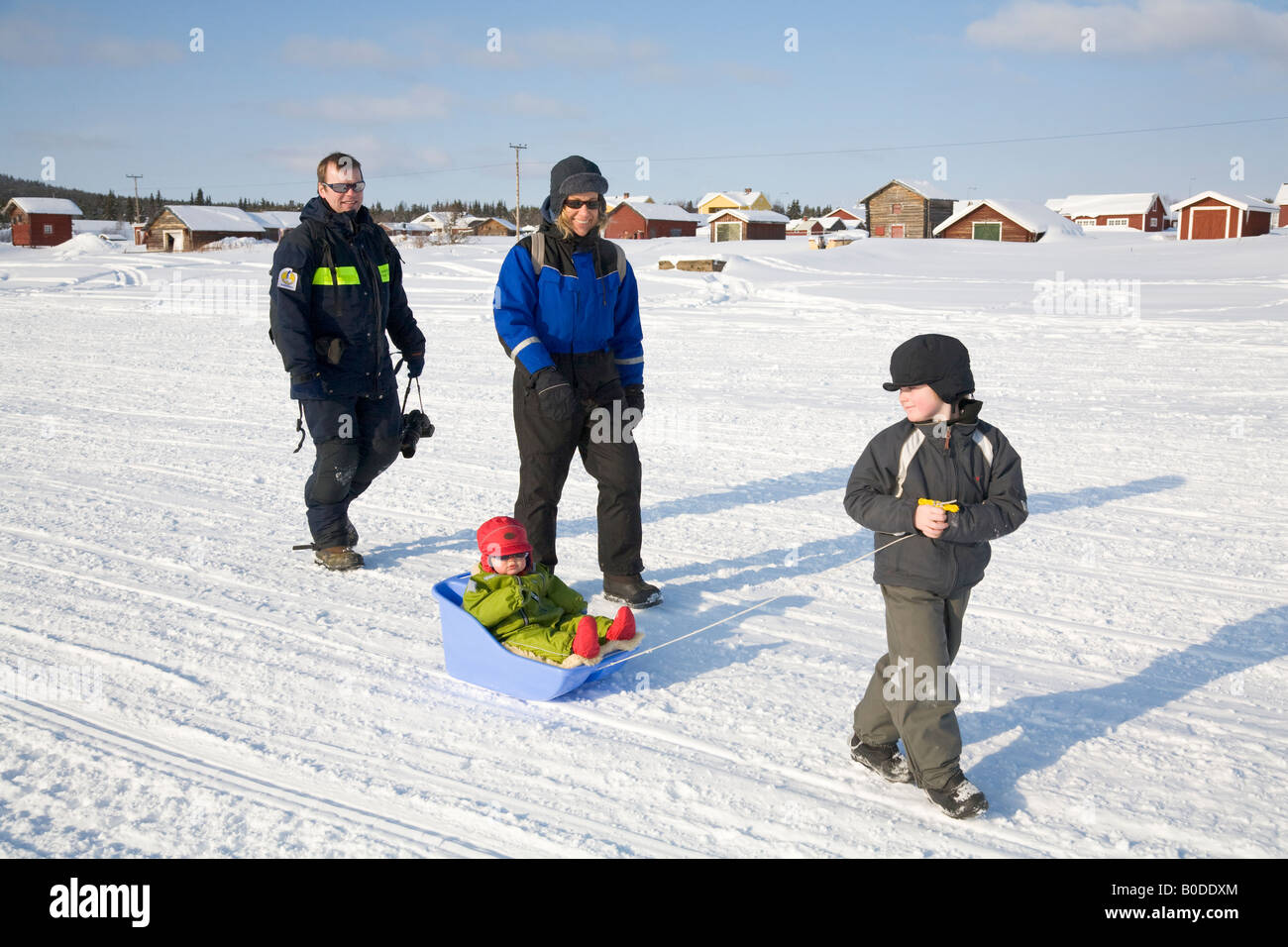 A family on a walk in the snow in northern Sweden Stock Photo