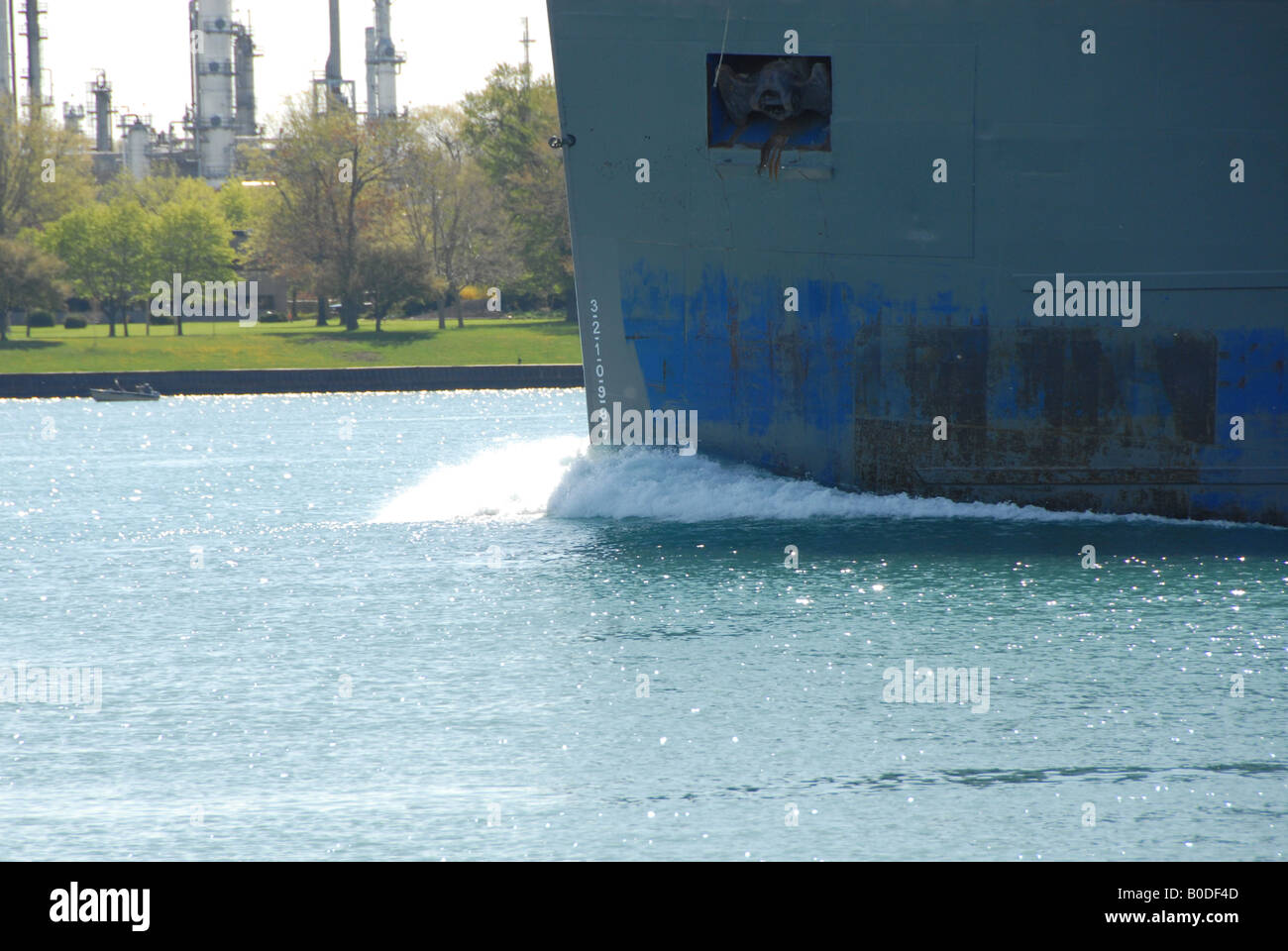 The bow of a freighter cuts through the water making waves. Stock Photo