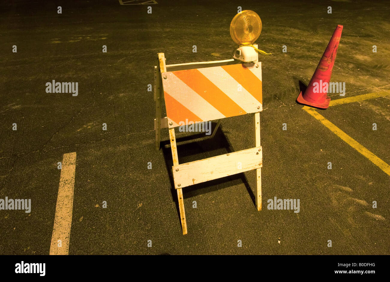 An orange traffic barricade at night. Stock Photo