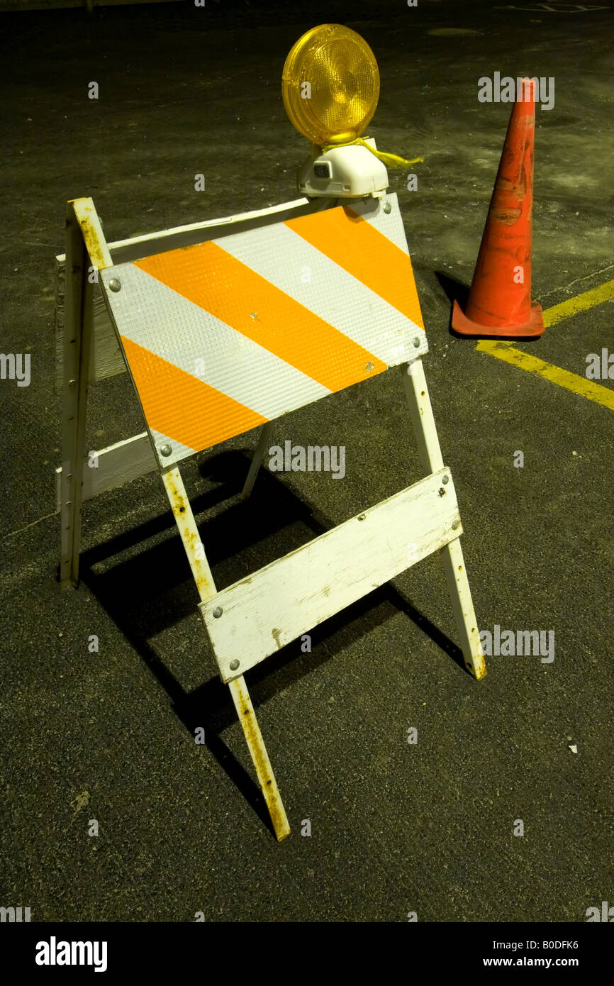 An orange traffic barricade at night. Stock Photo