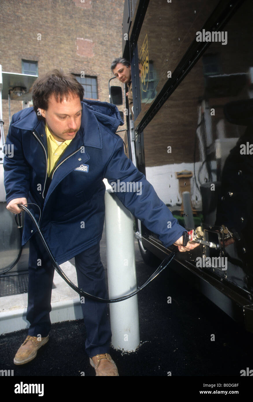 Con Edison worker refuels UPS delivery truck at their compressed natural gas refueling station in New York Stock Photo