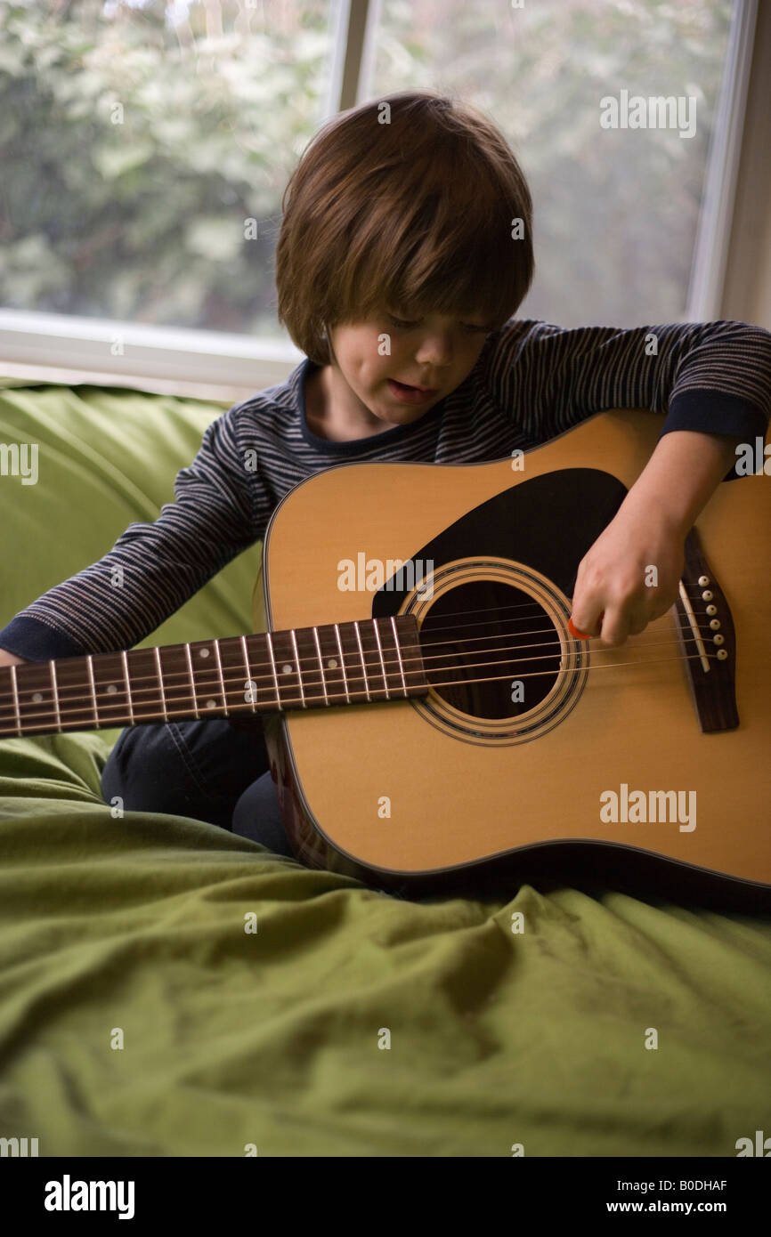five year old child playing acoustic guitar Stock Photo Alamy