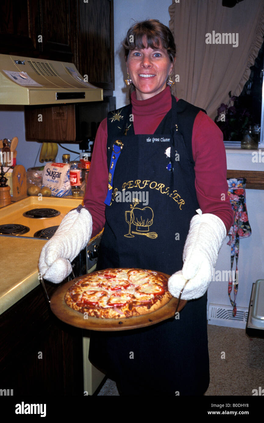 Woman holds a pizza. Stock Photo