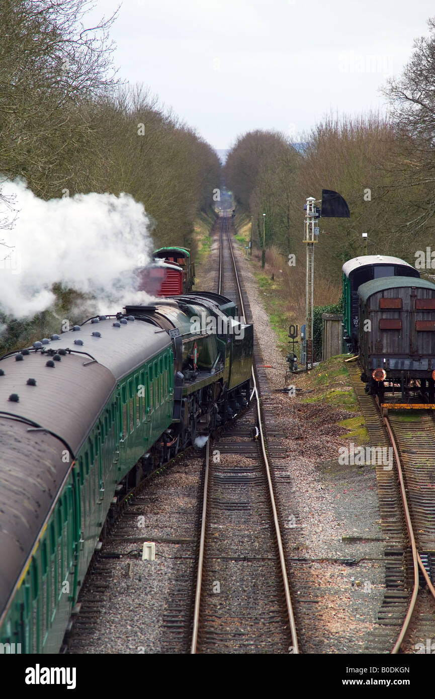 A steam train departing on the Watercress line between Medstead Four Marks and Ropley Stock Photo