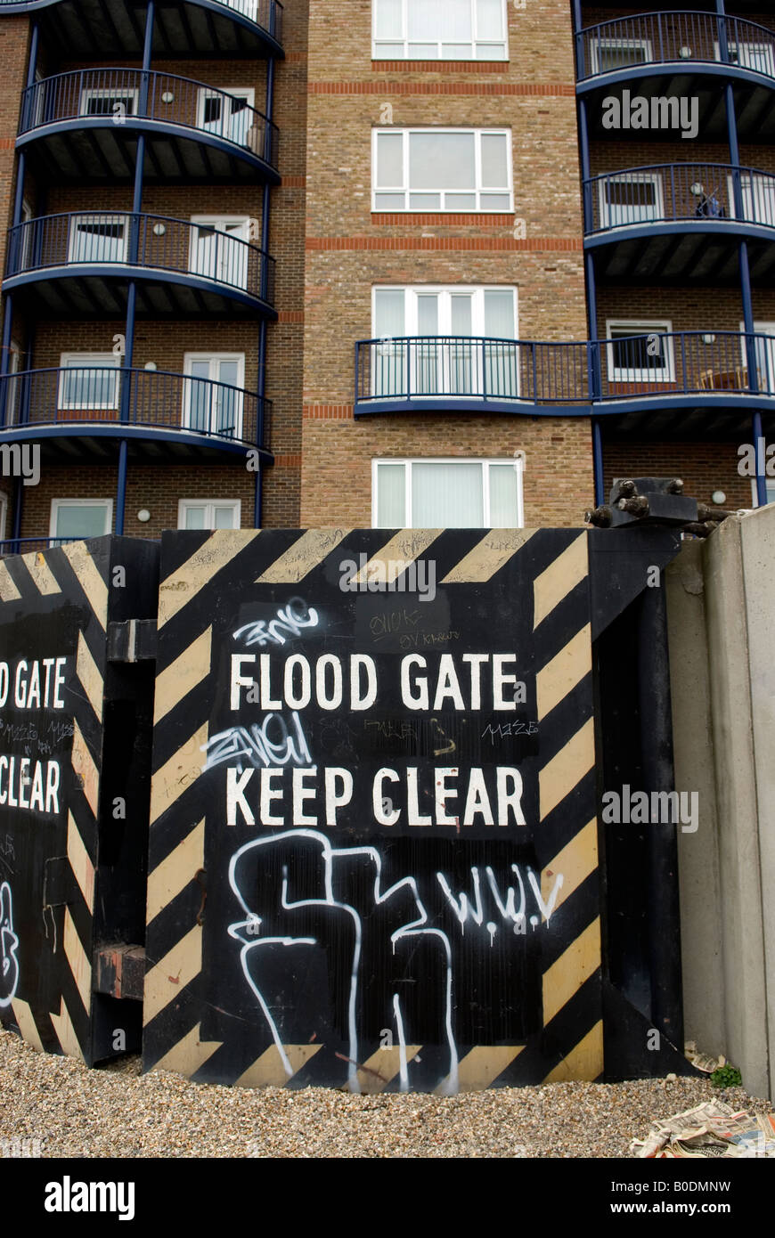 The River Thames at Grays in Essex showing modern new housing developments and the sea wall with flood gates to defend against t Stock Photo