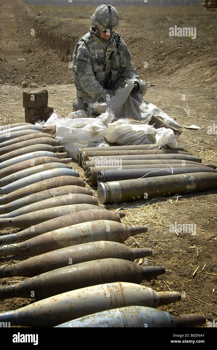 A U S Army soldier examines the contents of a bag from a discovered weapons cache outside Abu Thayla Iraq on April 13 2008. Stock Photo