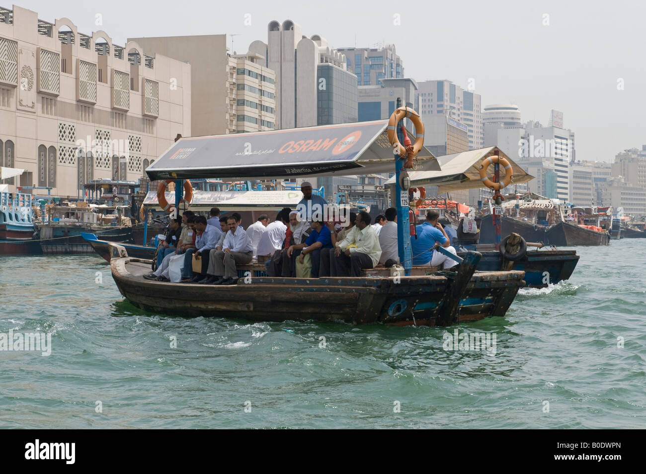 Dubai, United Arab Emirates (UAE). An abra (water taxi) taking passengers across Dubai Creek, which divides the city Stock Photo