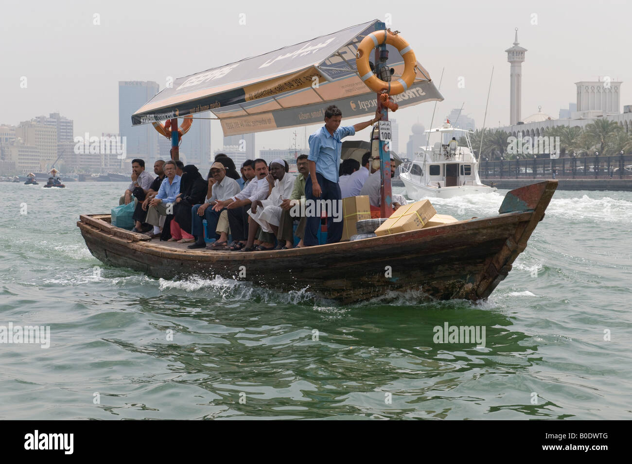 Dubai, United Arab Emirates (UAE). An abra (water taxi) taking passengers across Dubai Creek, which divides the city Stock Photo