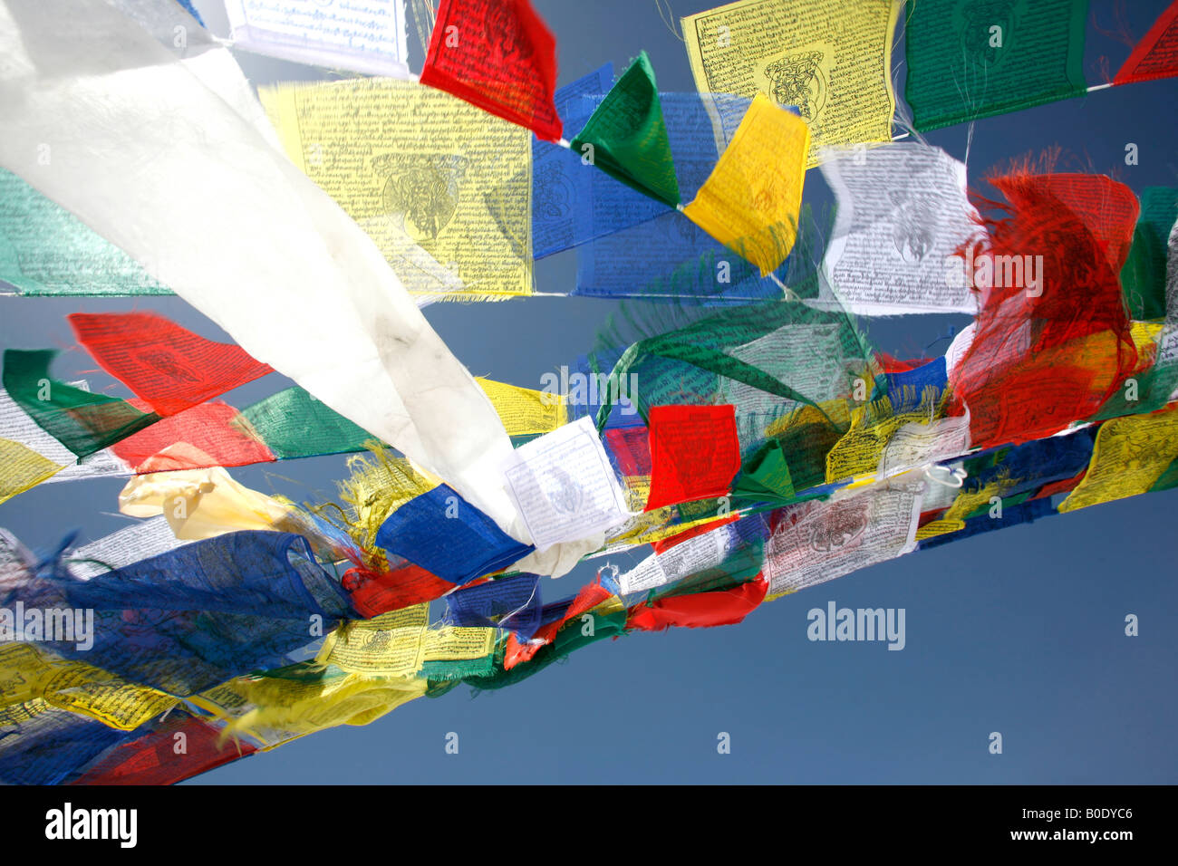 praying flags floating in the wind on blue sky Stock Photo - Alamy