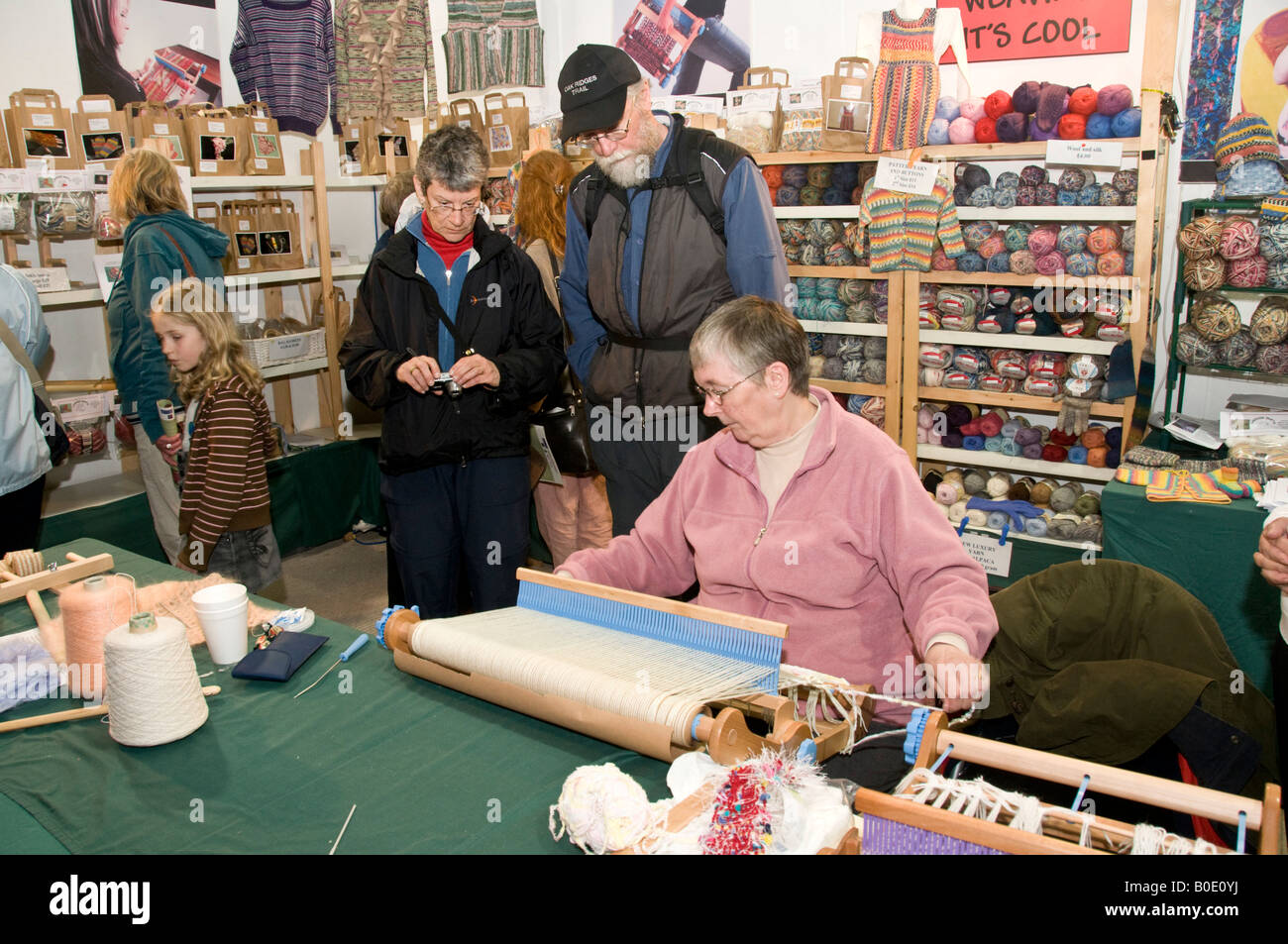 woman demonstrating weaving on a hand loom at the Wonderwool Festival