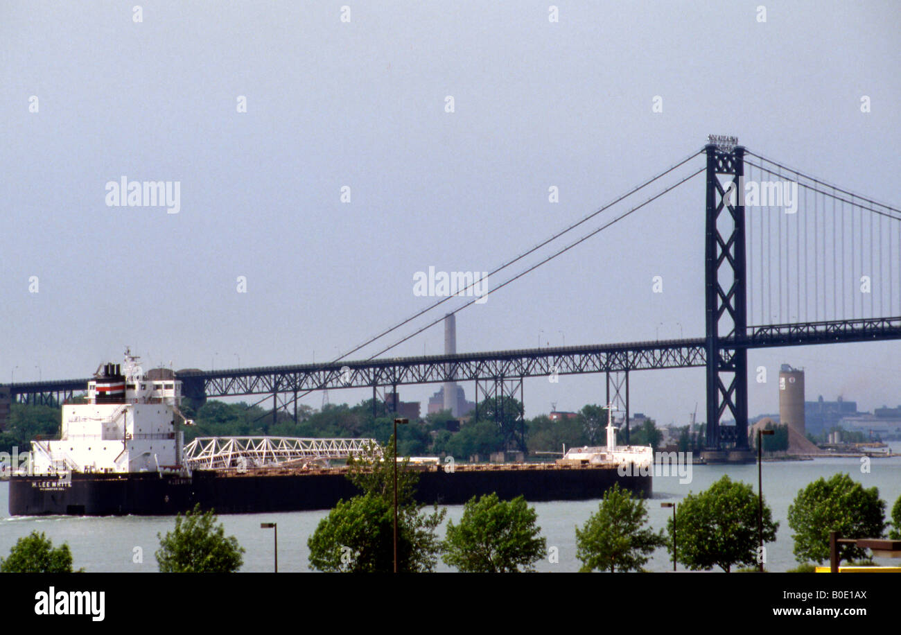 Ambassador Bridge with freighter on Detroit River in Detroit, Michigan, across from city of Windsor, Canada Stock Photo
