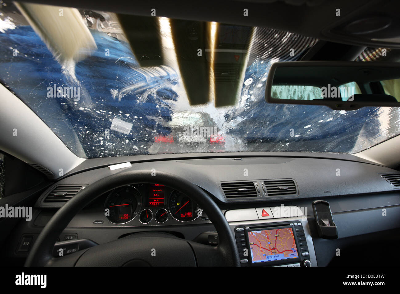 Car drives through a car wash machine. Stock Photo