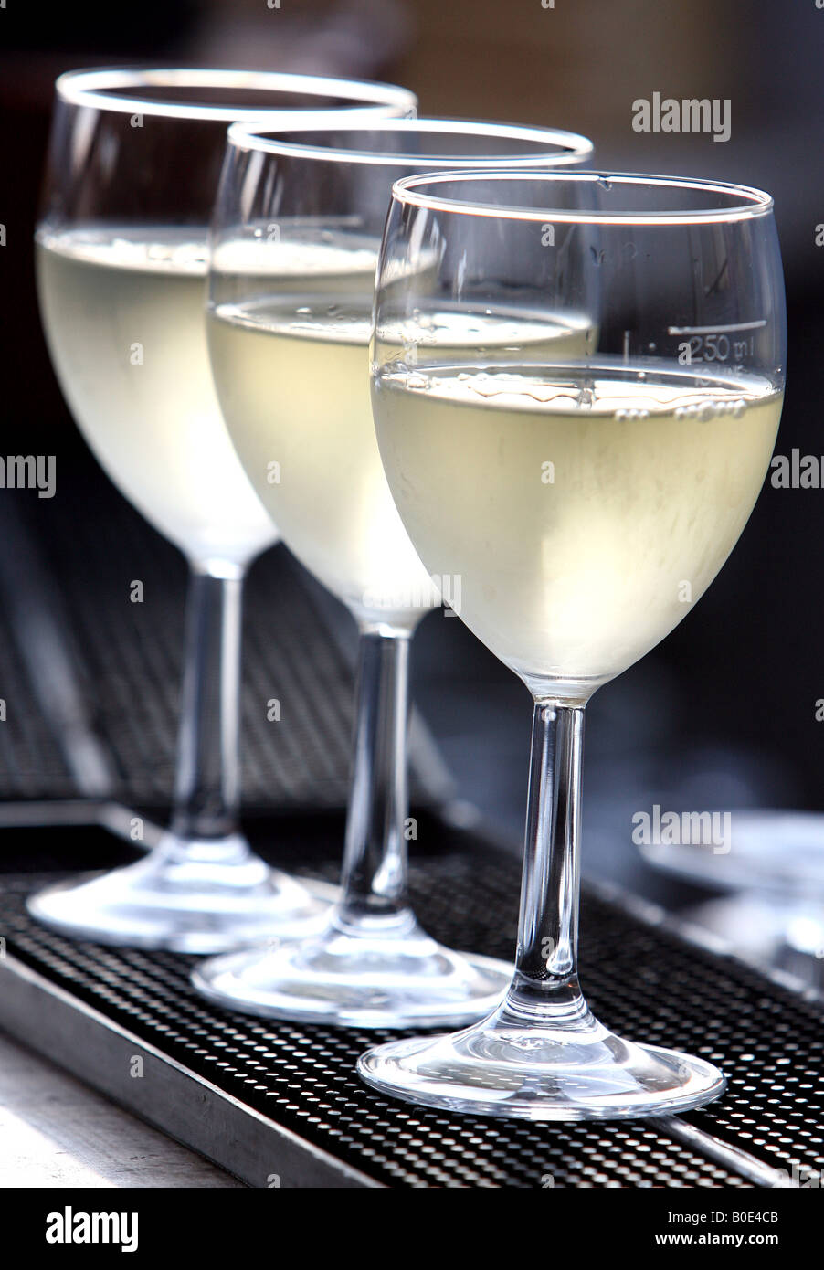 3 freshly poured glasses of white wine Stock Photo