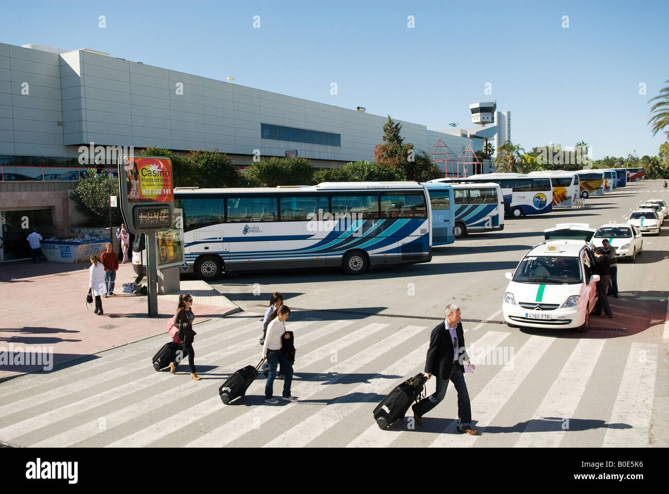 people with baggage and Buses in front of the terminal of Alicante