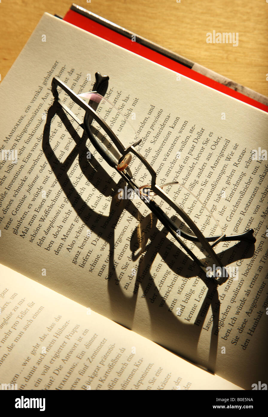 Reading glasses on an open book Stock Photo