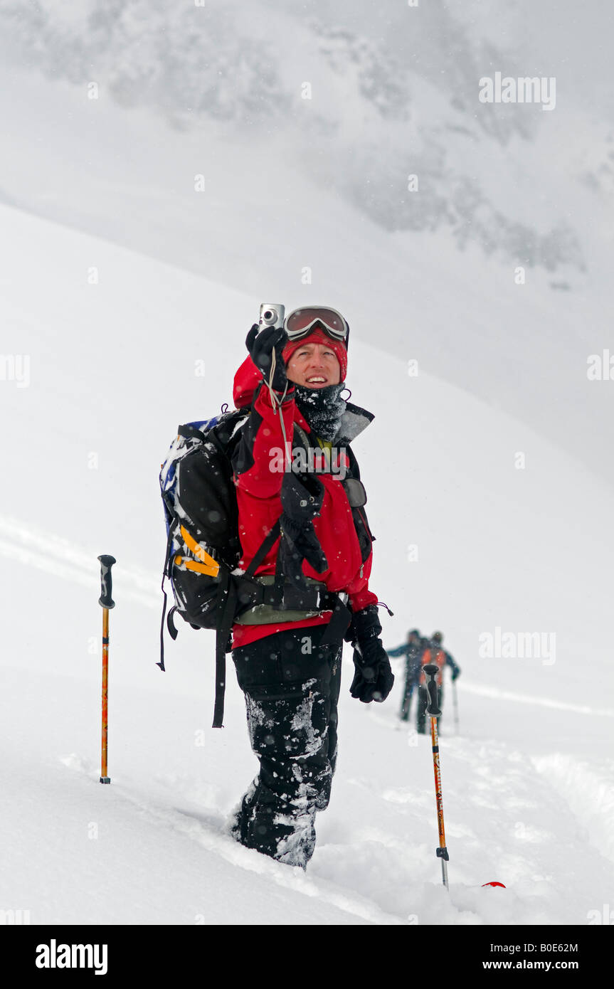 skier taking a photo with his Canon PowerShot digital camera, Asulkan Glacier, Selkirk Mountains, British Columbia, Canada Stock Photo