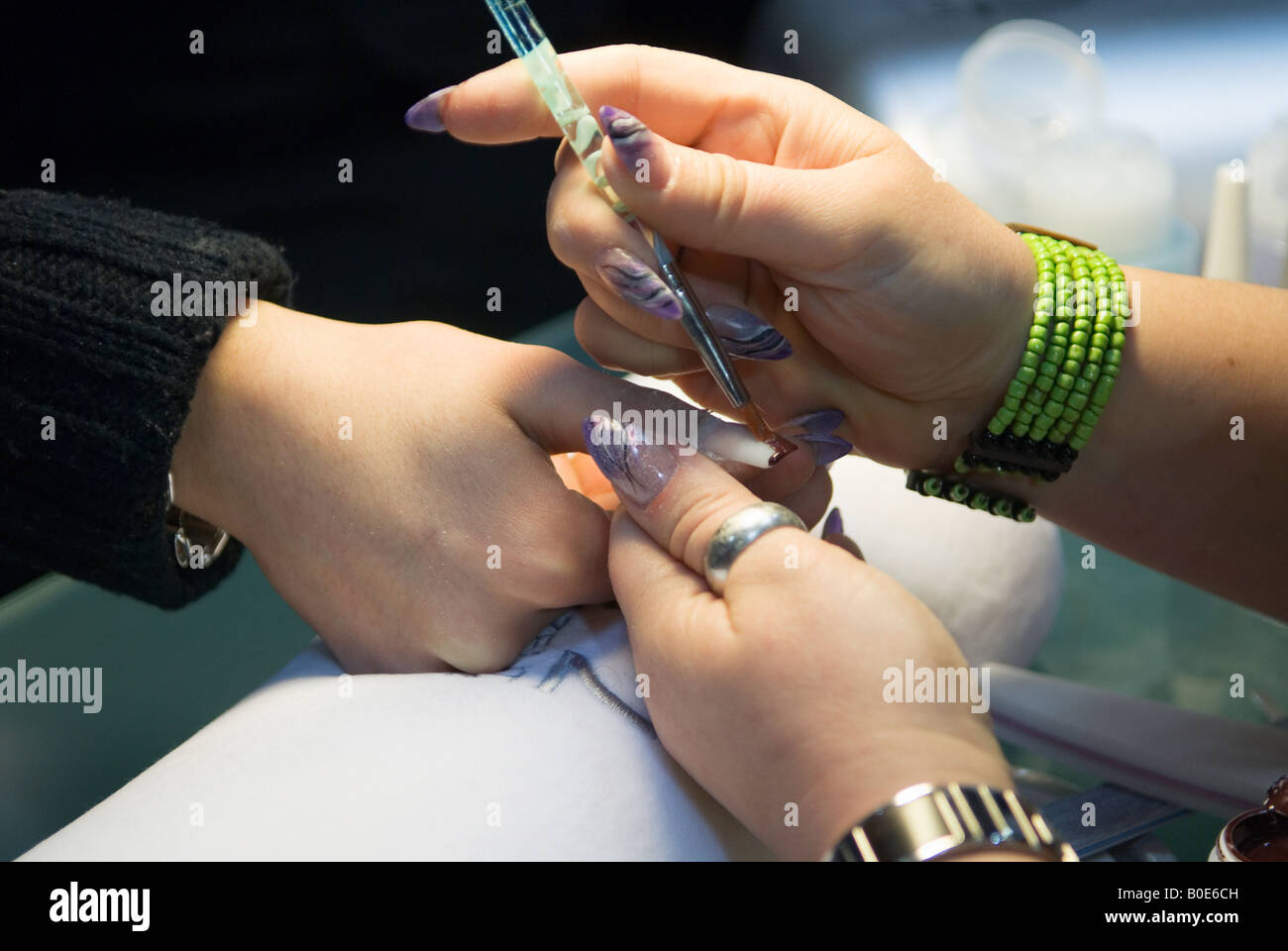 beautician treats a womans fingernails Stock Photo