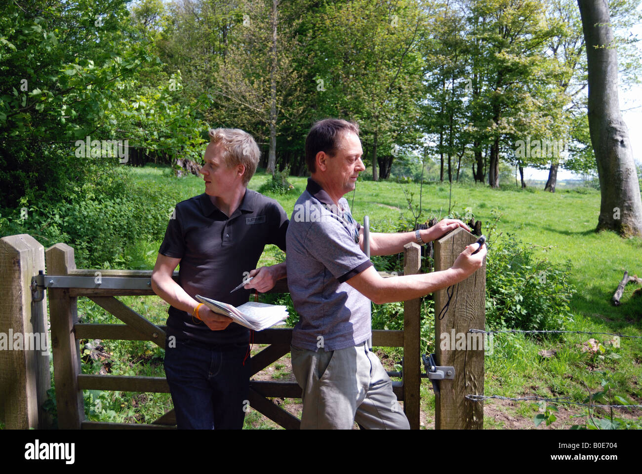 Two men walking and plotting route with GPS Stock Photo