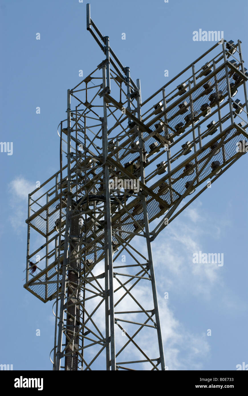 Football floodlight tower against deep blue sky Stock Photo