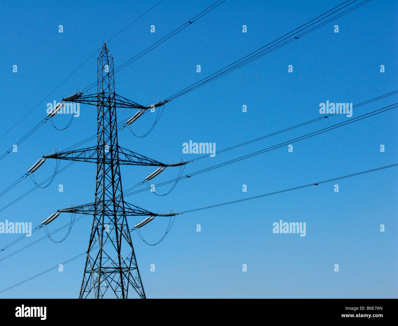 Electricity Pylon set against a blue sky Stock Photo - Alamy