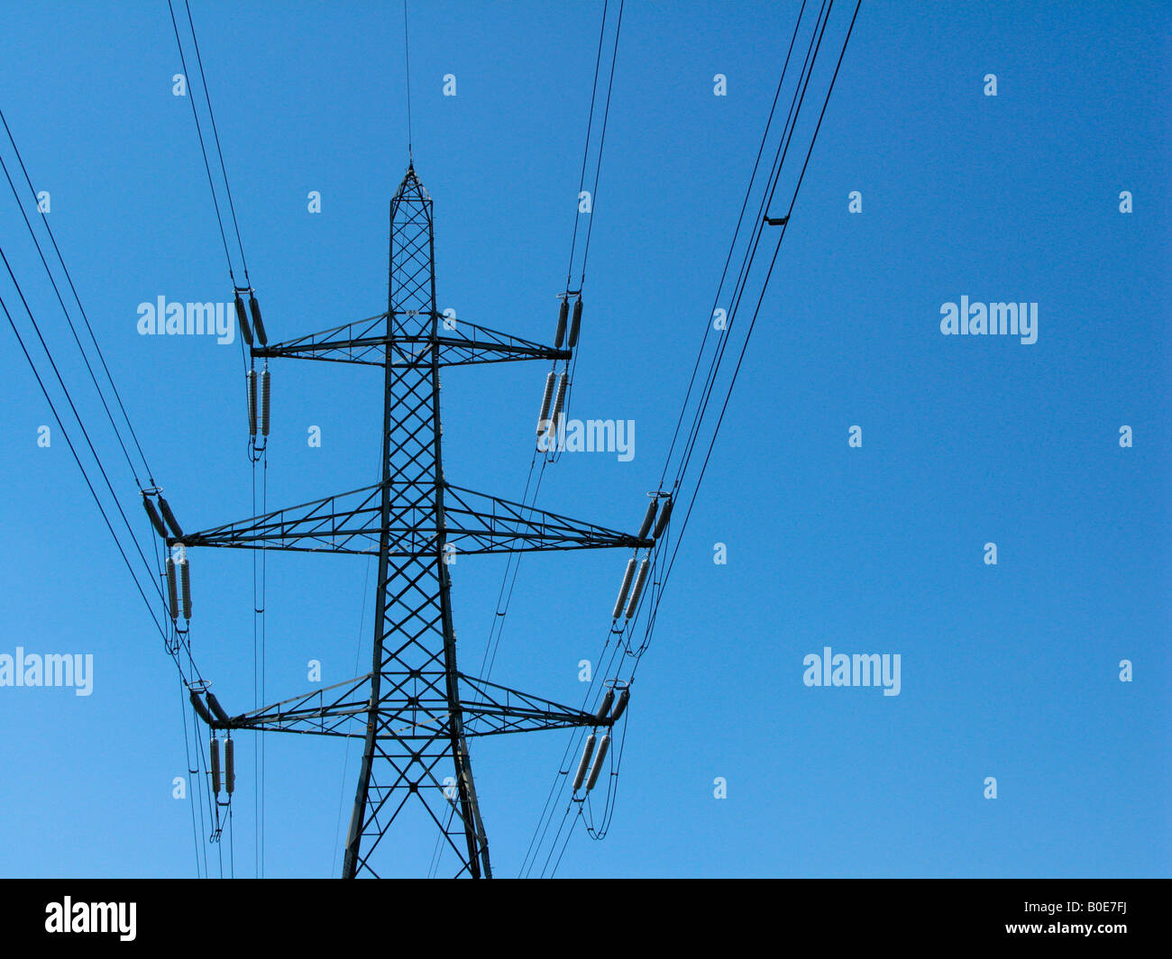 Electricity Pylon set against a blue sky Stock Photo - Alamy
