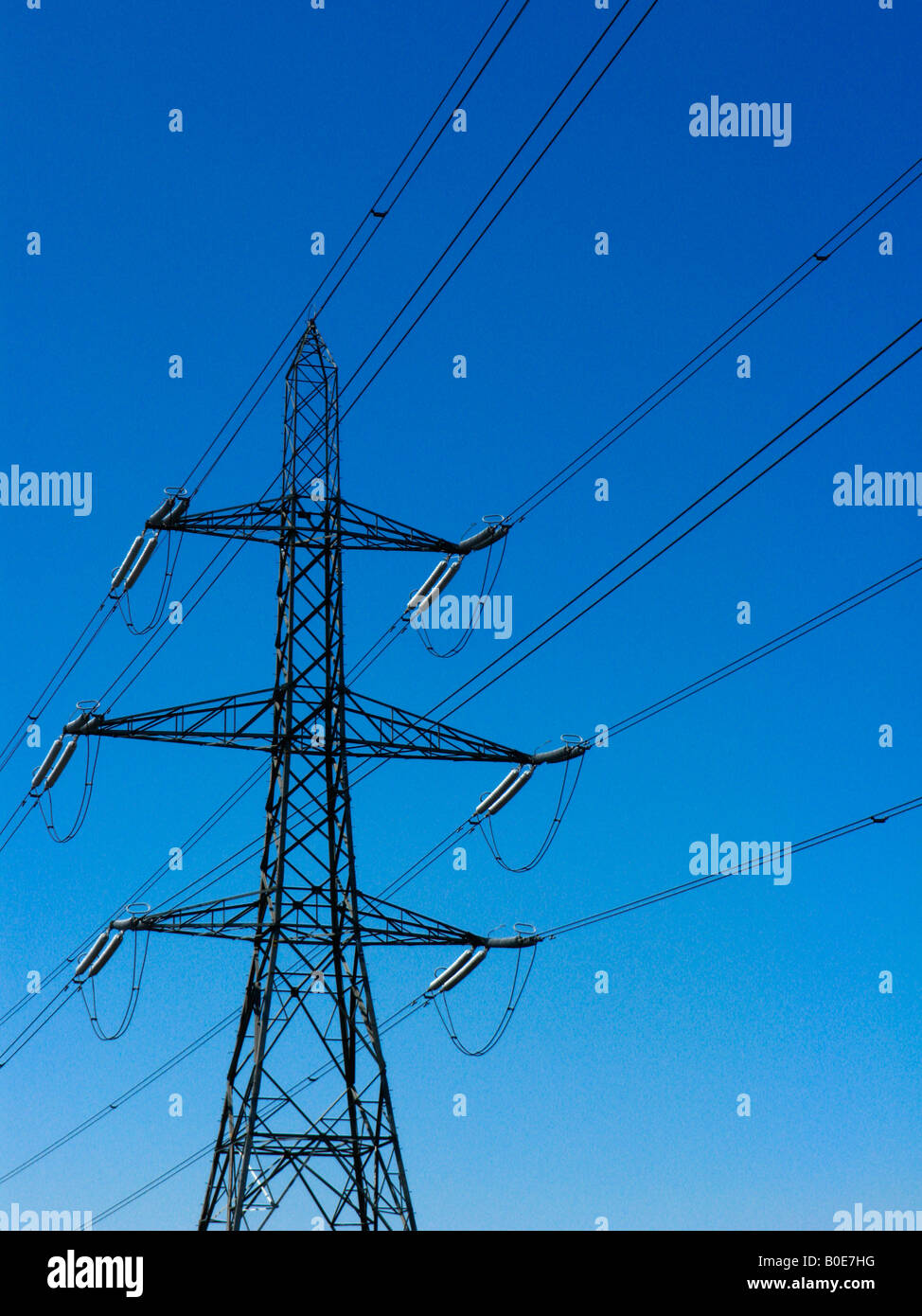 Electricity Pylon set against a blue sky Stock Photo - Alamy