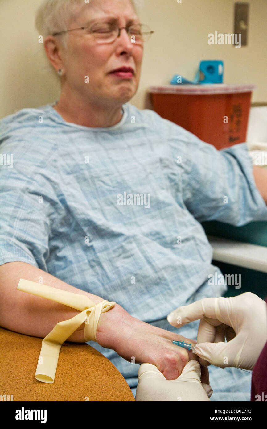 Patient prepares for CT scan during clinical trial of new cancer treatment Stock Photo