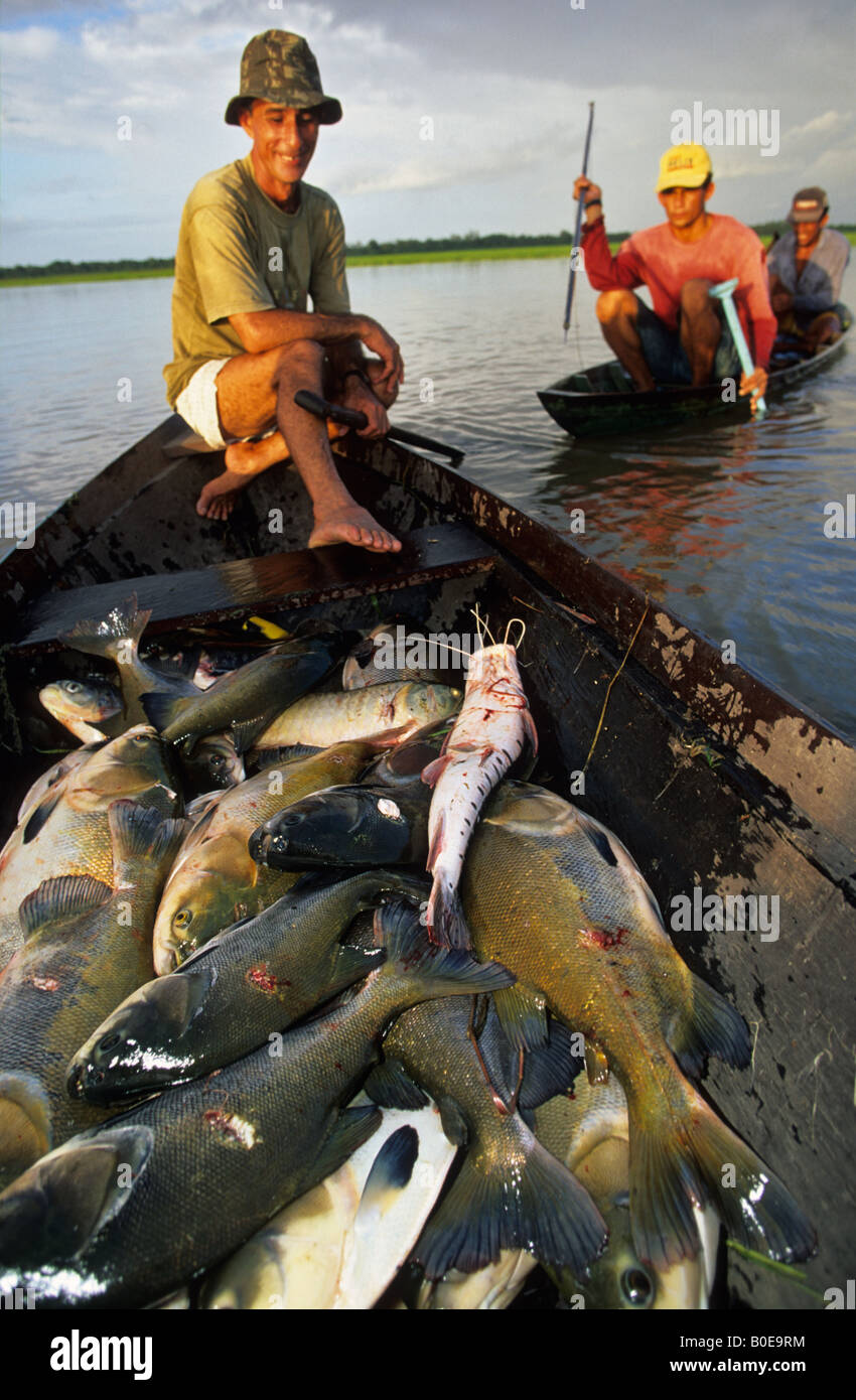 harpoon fishermen from a remote fishing community in dugout canoe out