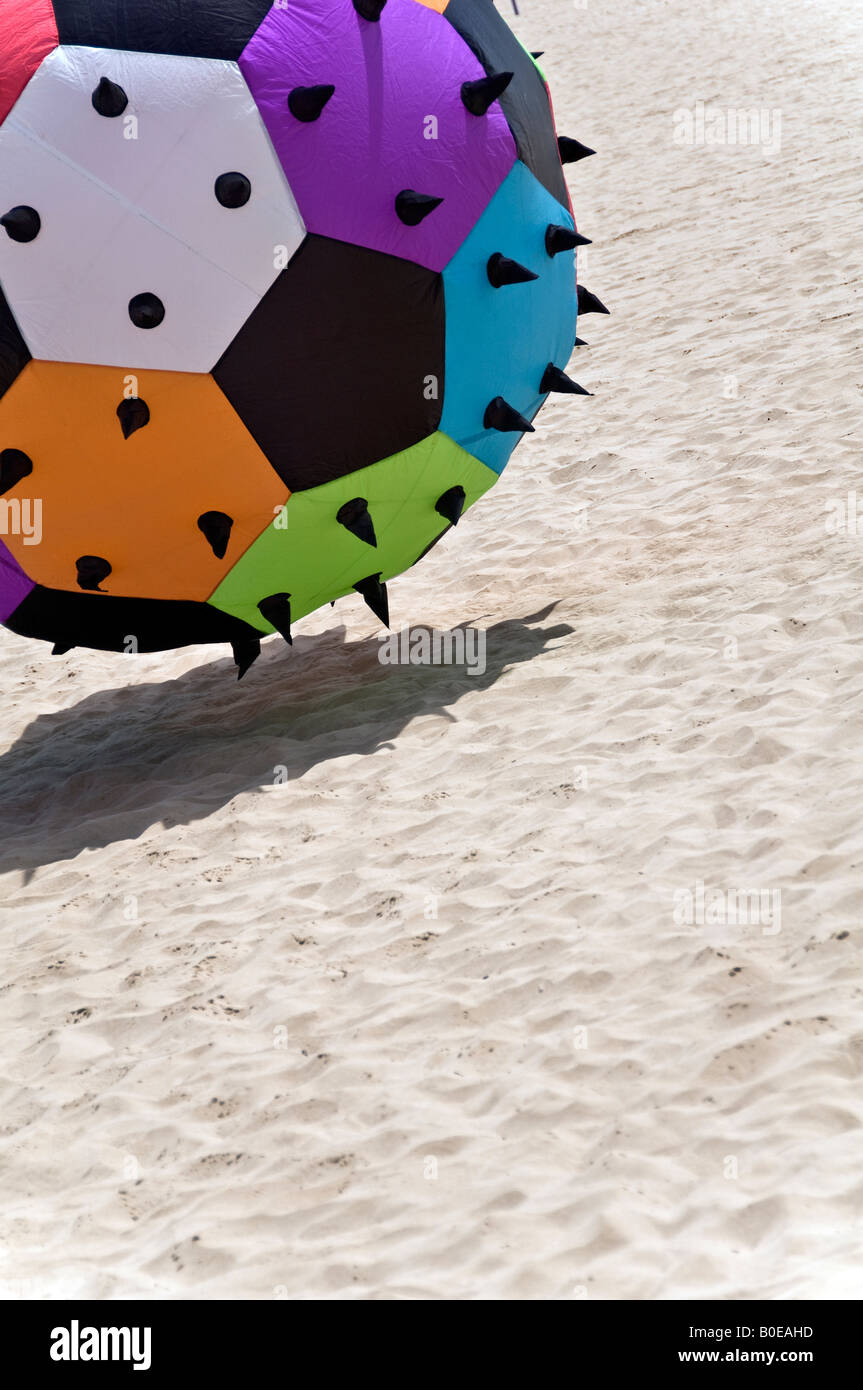 giant spiky ball bouncing along the sandy beach Stock Photo