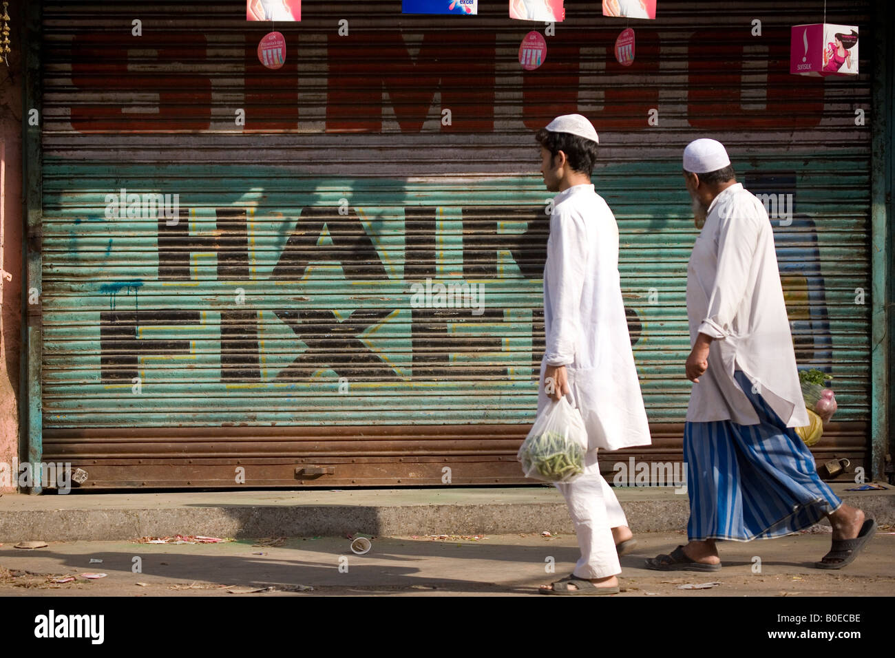 Two Muslim men walk in the Paharganj Market of New Delhi. Delhi has a large Muslim community. Stock Photo