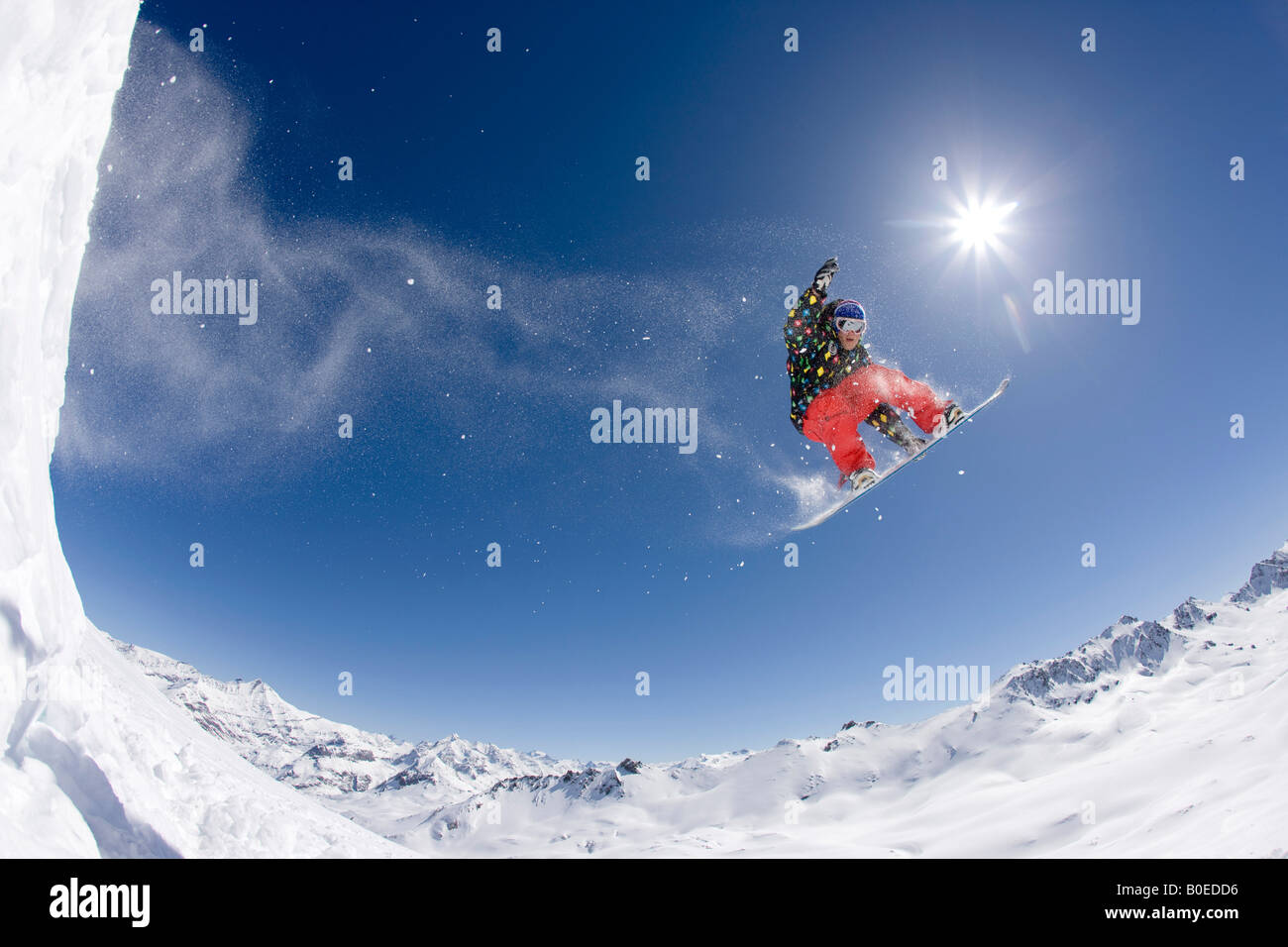 Snowboarder Jo Howard spinning across the French Alps Stock Photo