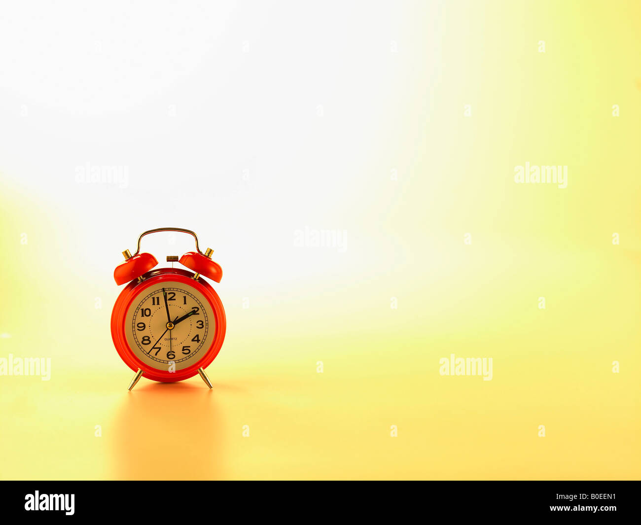 A red alarm clock Stock Photo - Alamy