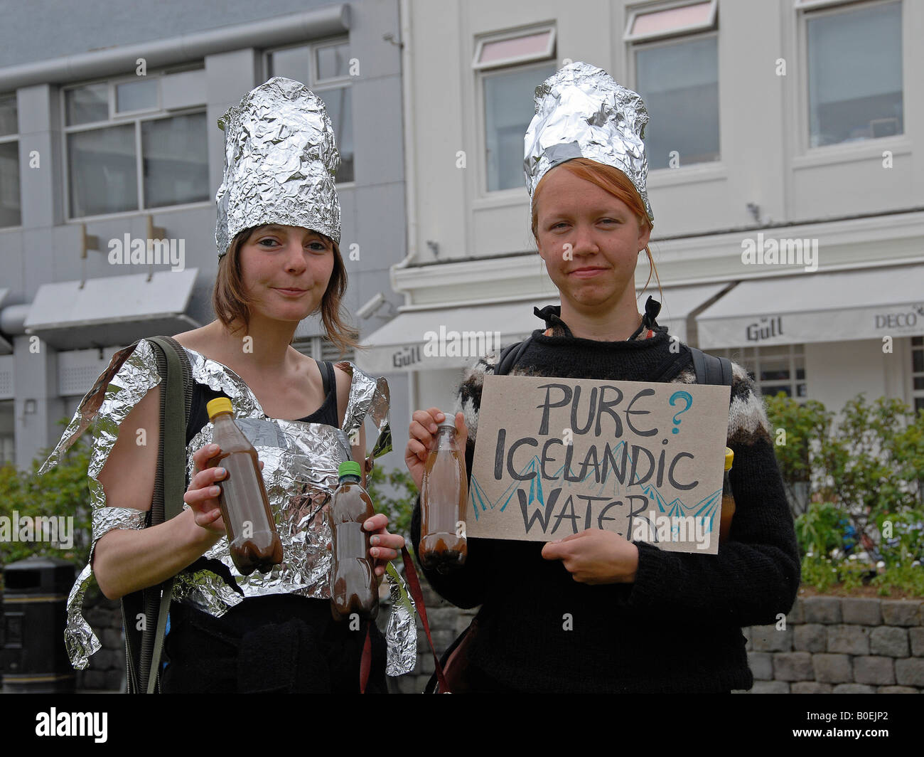 Two girls, in action against pollution and for clean pure Icelandic water, in the streets of Reykjavic. Stock Photo