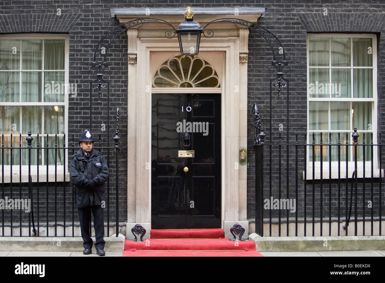 Armed policeman guards Number 10 Downing Street official home of the British Prime Minister London UK Stock Photo