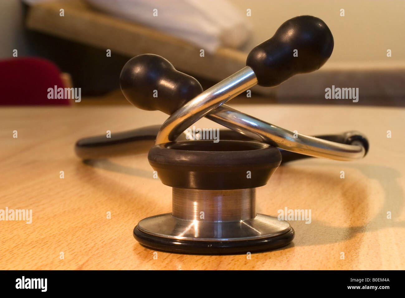 Doctor's GP family physician consulting room office showing stethoscope and examination couch England Great Britain GB UK Stock Photo