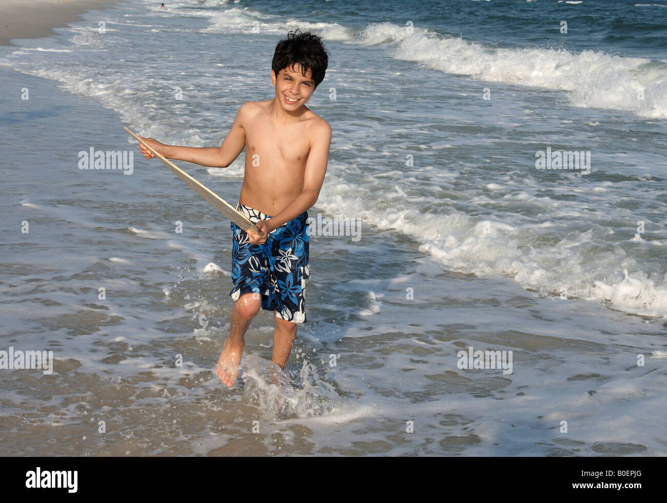 A young boy about to jump on a skim board on the Alabama Gulf Coast. Stock Photo