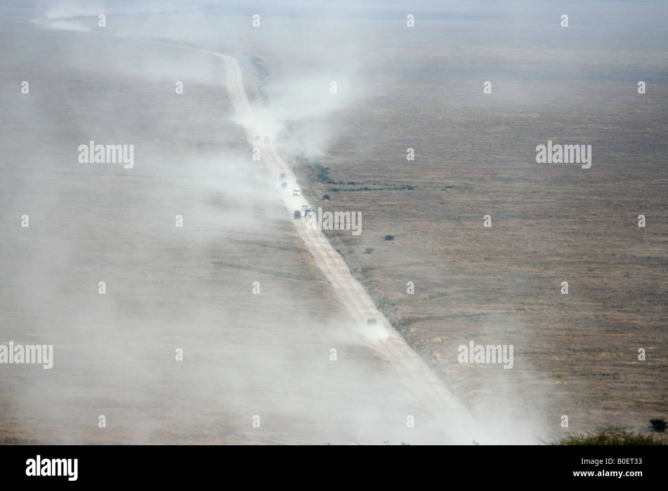 Dusty road in savanna - safari on the Serengeti Plains Stock Photo