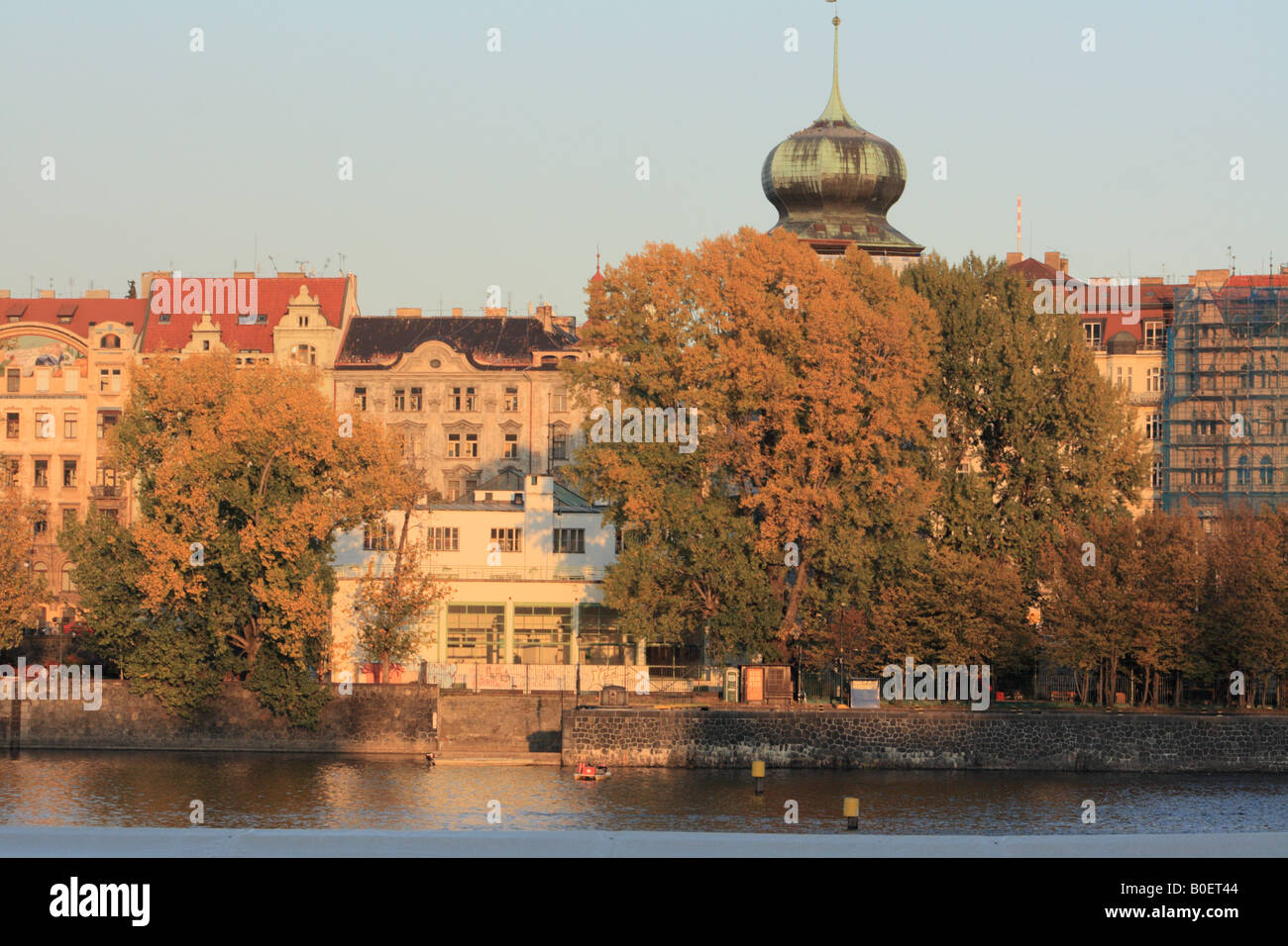 Boaters swarm in the water beneath Manes on a lovely golden October evening in Prague Stock Photo