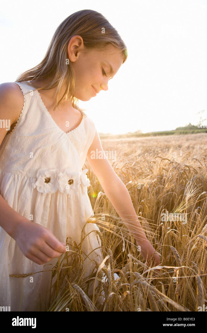 Young girl standing in corn field Stock Photo - Alamy