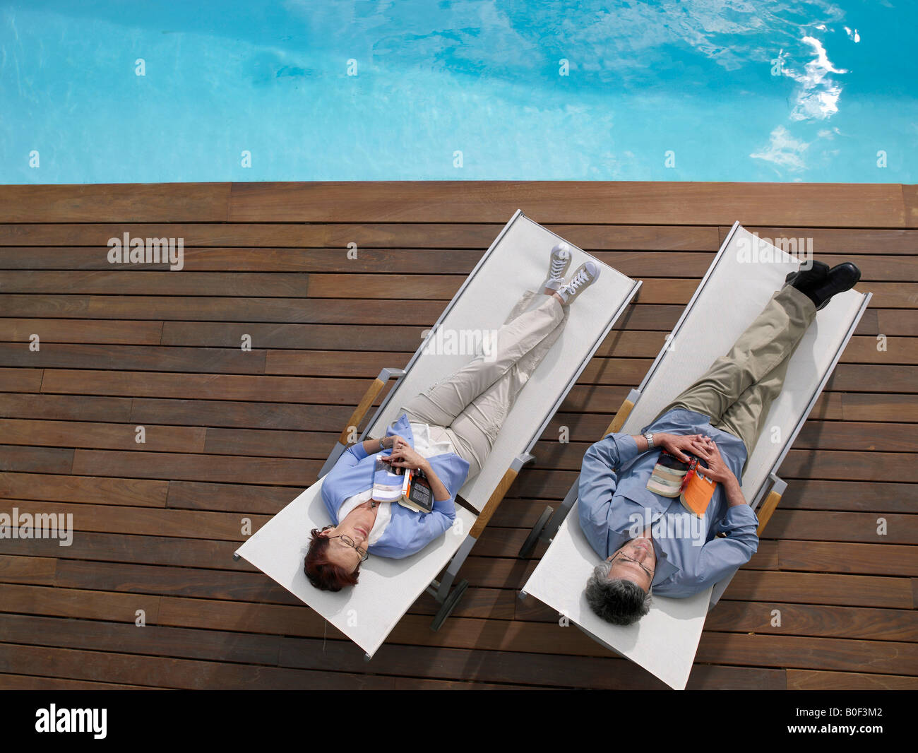 Couple by the swimming pool high angle hi-res stock photography and ...
