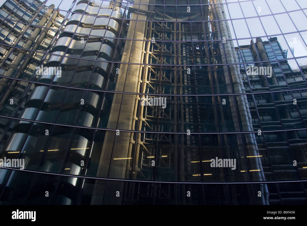 The Lloyds Building reflected in the windows of The Willis Building London England United Kingdom Stock Photo