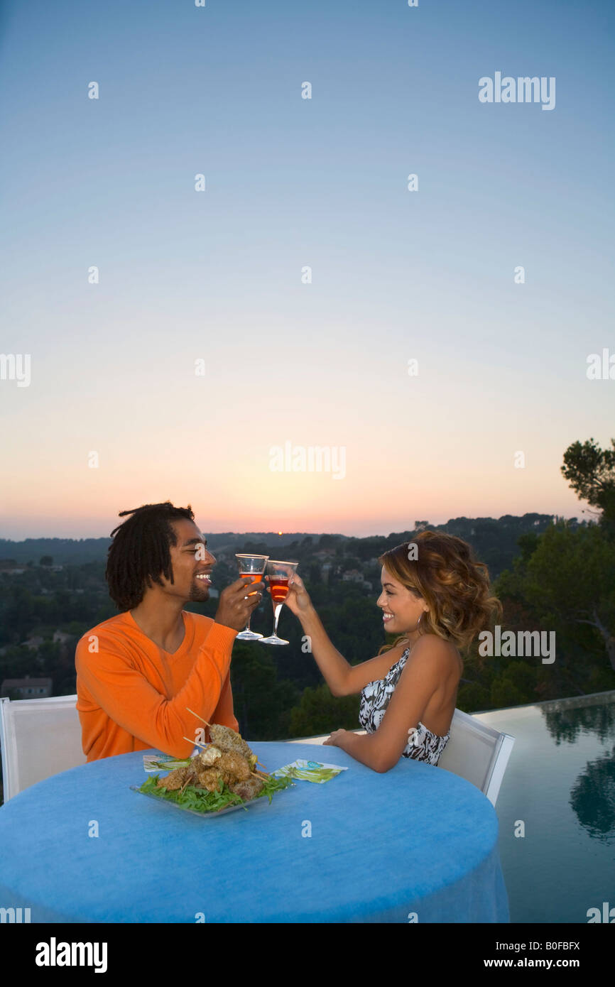Young couple having dinner at sunset Stock Photo