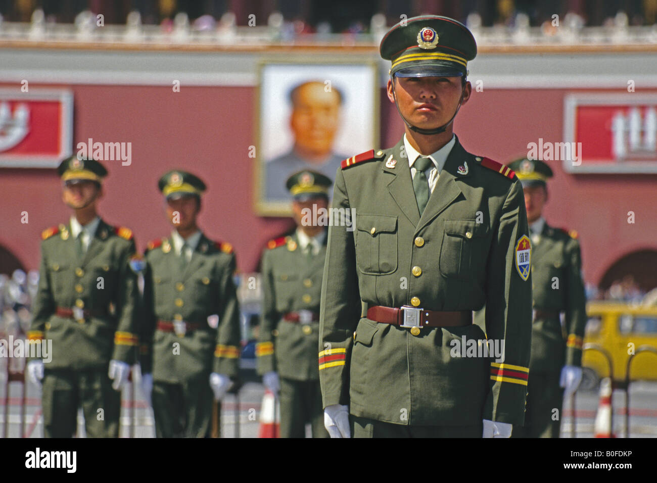 Guards in Tiananmen Sqaure in front of portrait of Mao Zedong on Gate of Heavenly Peace (Tiananmen Gate) Stock Photo