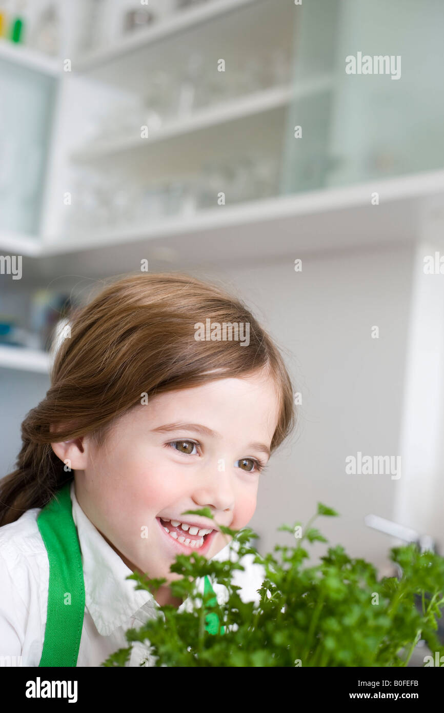 Girl smelling parsley Stock Photo Alamy