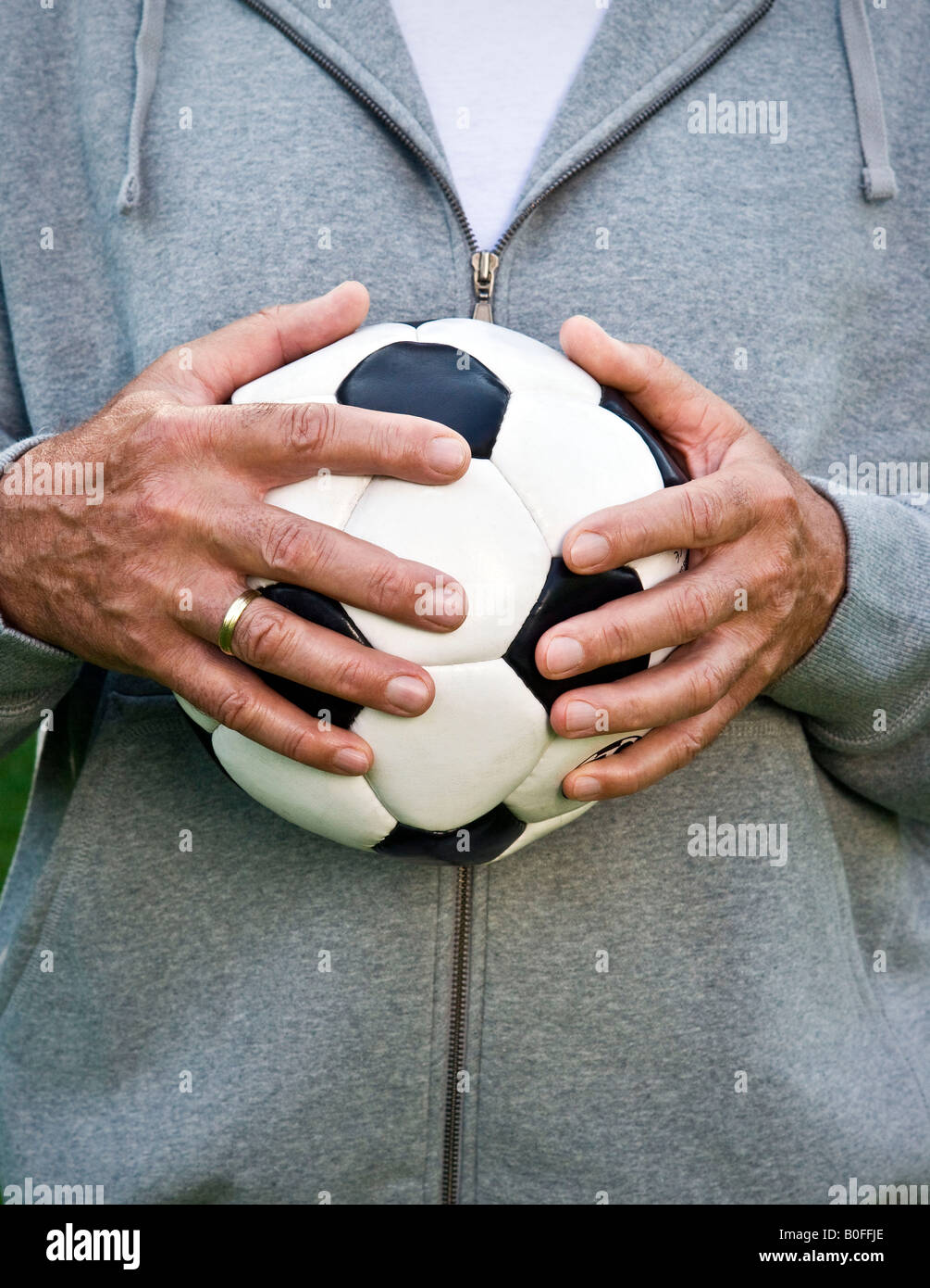Hands holding football hires stock photography and images Alamy