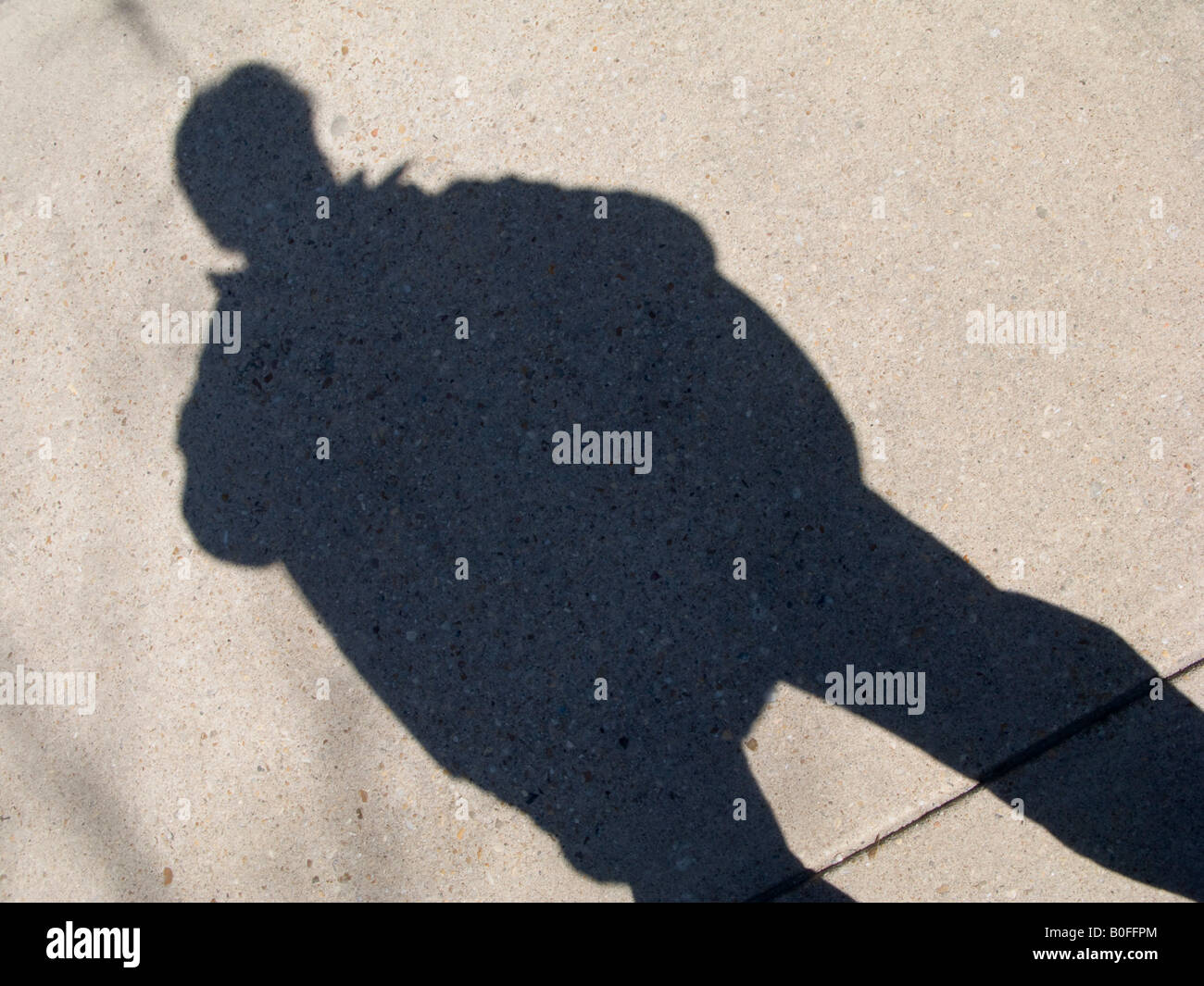 Shadow of man on a sidewalk Stock Photo