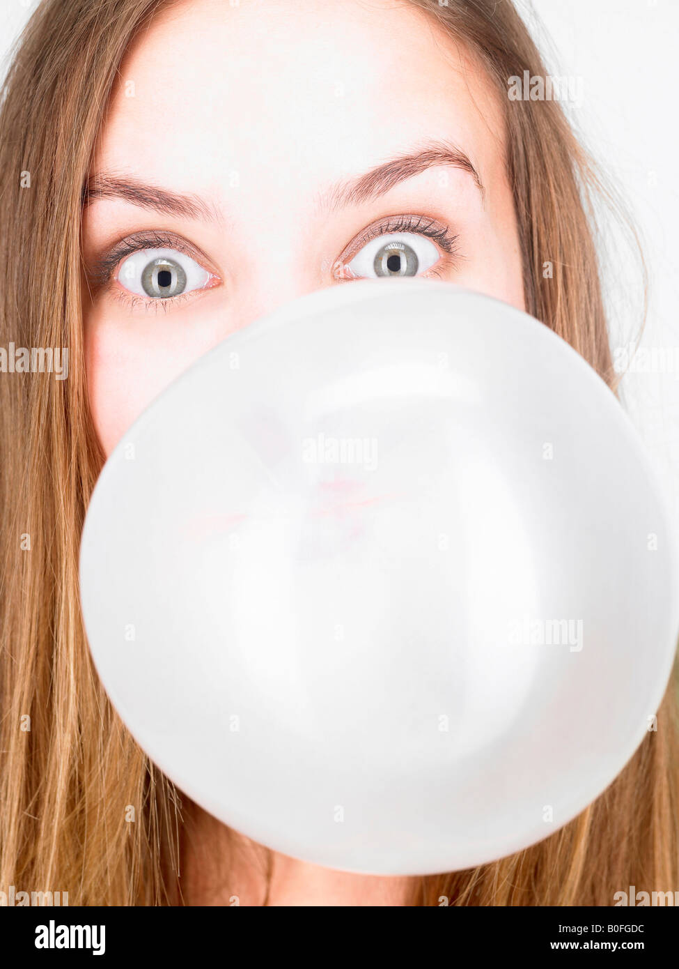 Woman blowing up a bubble gum Stock Photo