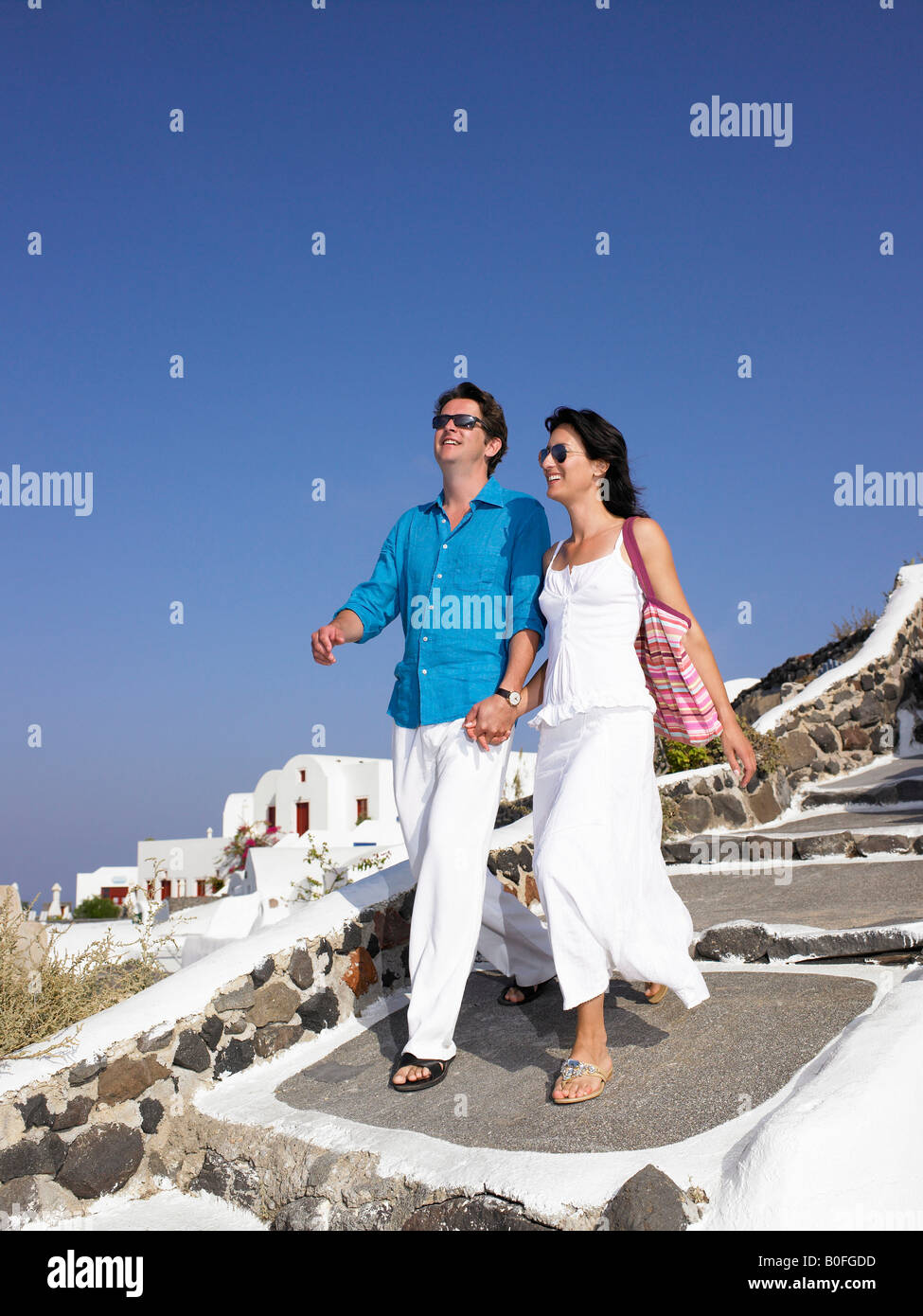 Couple climbing down the stairs Stock Photo