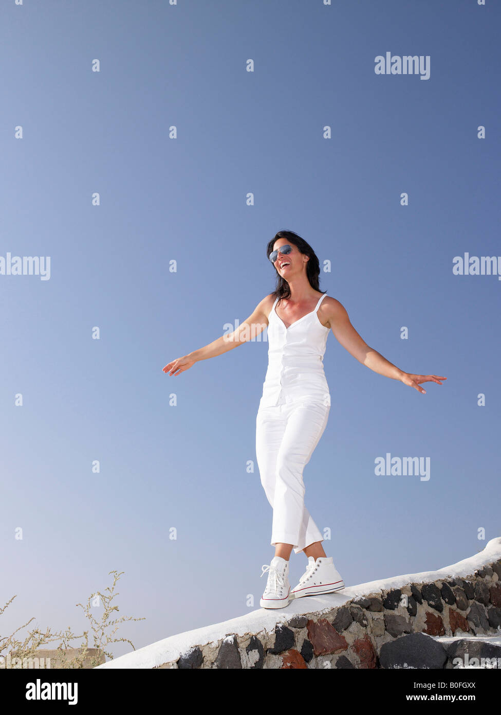 Woman with outstretched arms on a cliff hi-res stock photography and ...